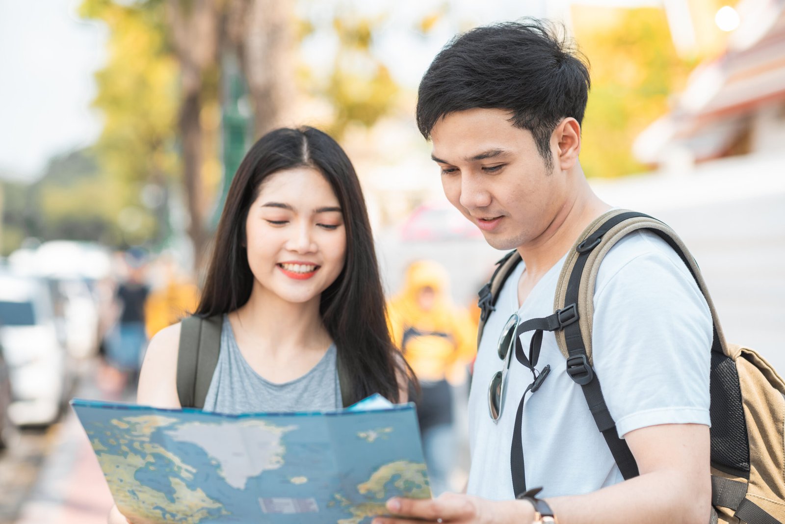traveler asian couple direction on location map in bangkok, thai